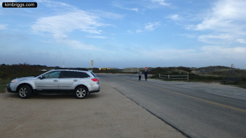 Subaru Outback parked on beach road.