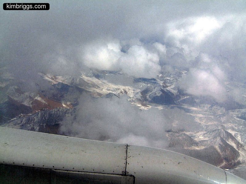 Clouds and mountains with snow from above.