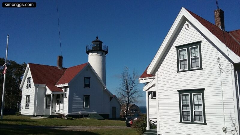 white houses in front of lighthouse