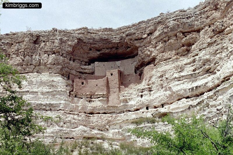 Primitive building built in side of cliff.