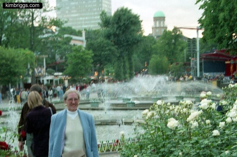 Woman at fountain in TIvoli Gardens in Denmark.