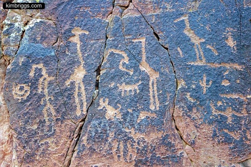 Petroglyphs on black rocks.