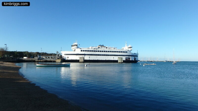 Large car ferry at dock.