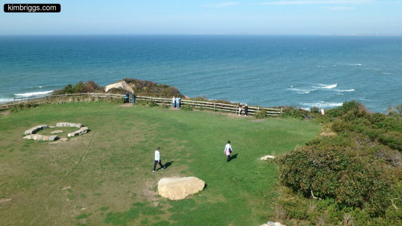Grass lawn on hill above ocean