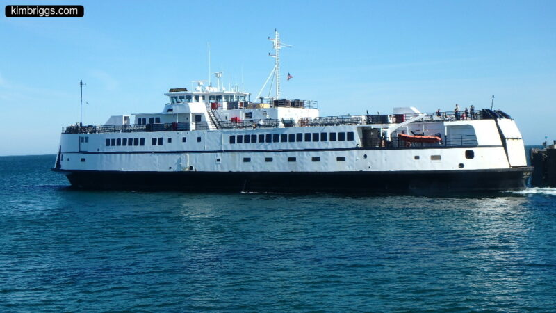 White ferry boat in dock.