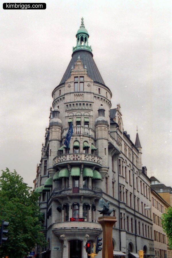 Corner stone, European building with round turrets.