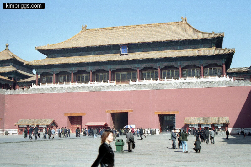 Forbidden City building with small crowd in front.