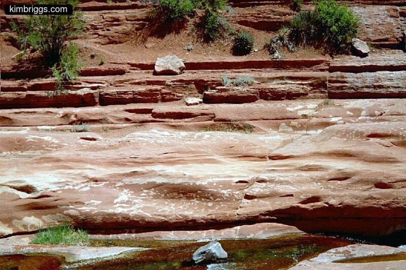 Red rocks made smooth by water.