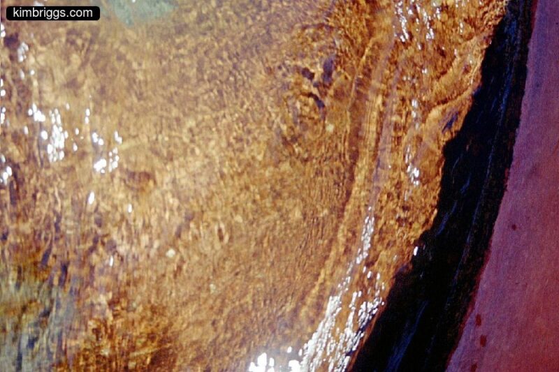 Close up of water flowing over rocks.