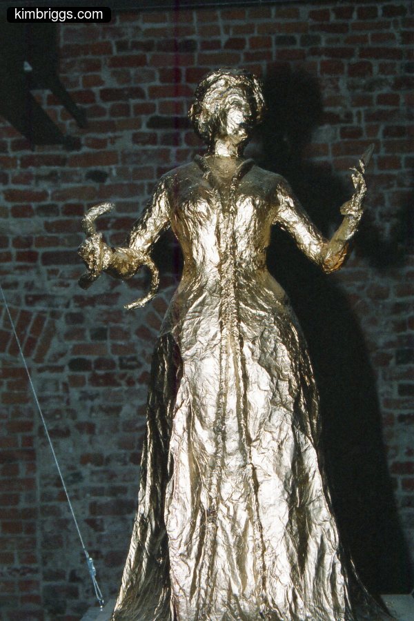 Sculpture of Victorian woman in long dress.