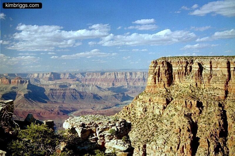 Blue sky and layered canyon walls of many colors.