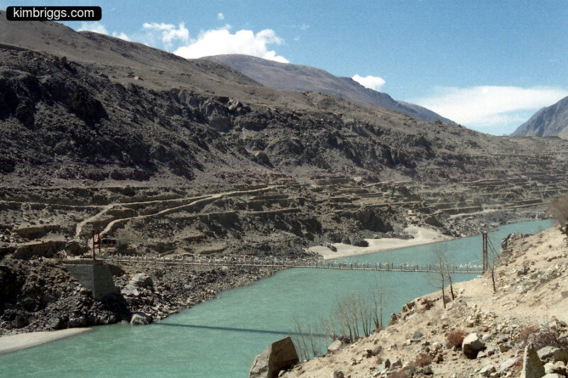 Small suspension foot bridge over Tibetan river.