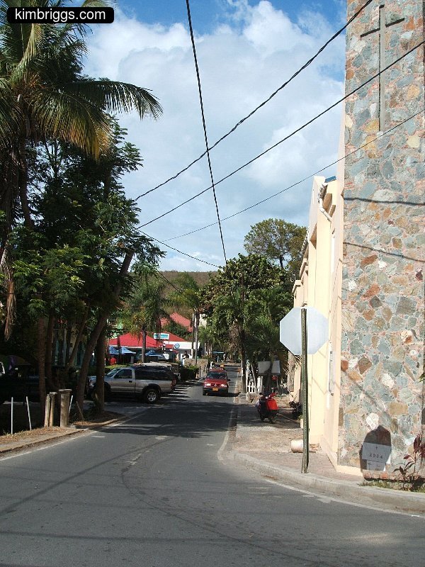 Small road next to stone church.