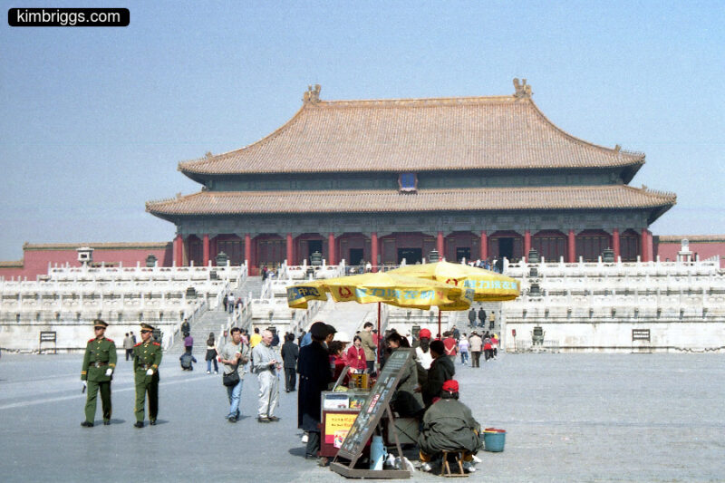 Vending cart and military men in Forbidden City.