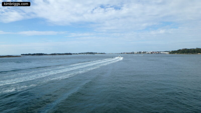 Small motorboat with wake.