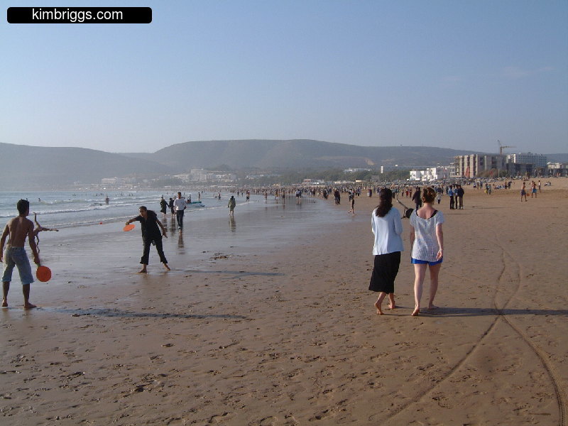 People walking and playing on Agadir beach.