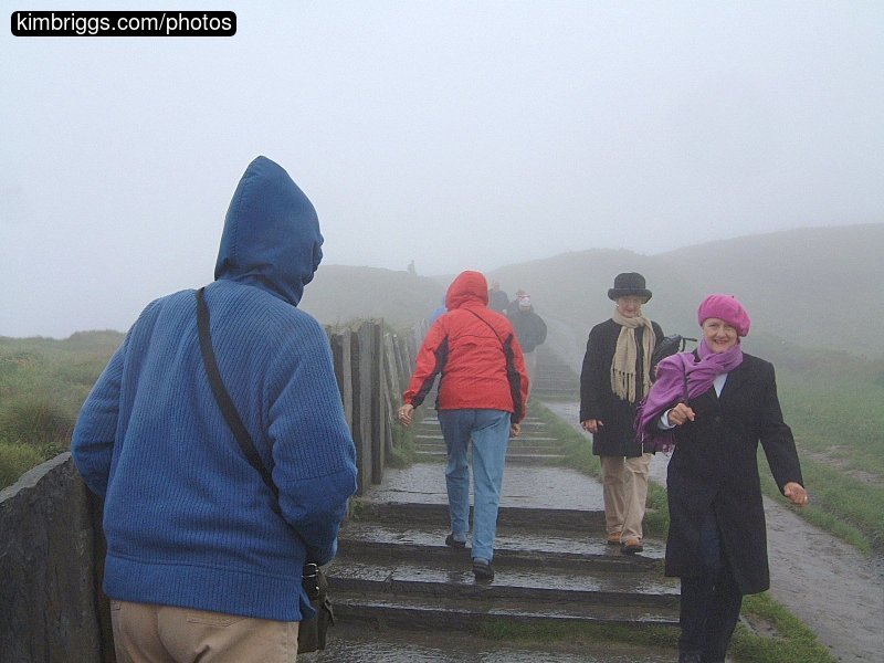 People on path in heavy fog.