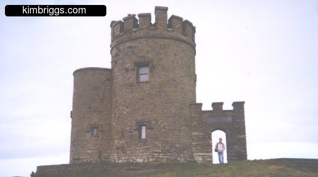 Small stone tower with arched entry.