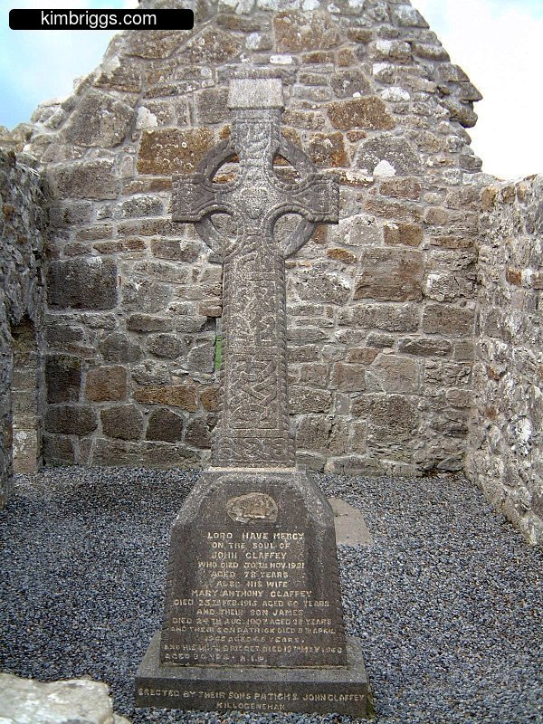 Irish high cross inside stone building.