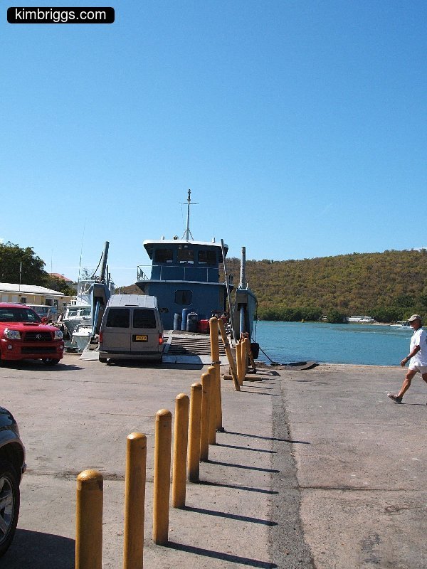 Cement dock with small car ferry.