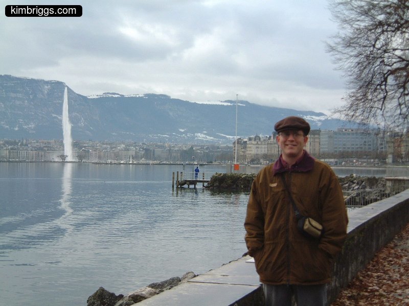 Man standing in front of Jet D'eau in Geneva.