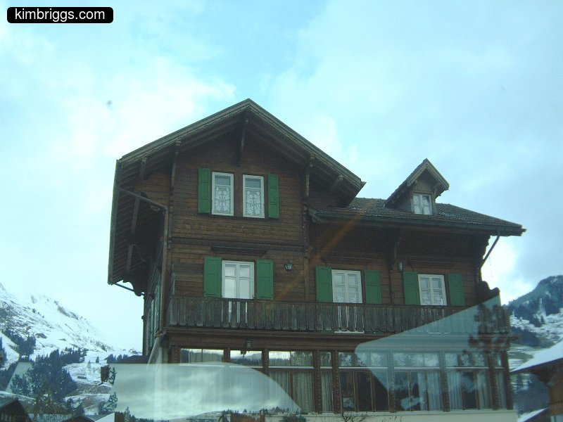 Swiss home with large covered porch.
