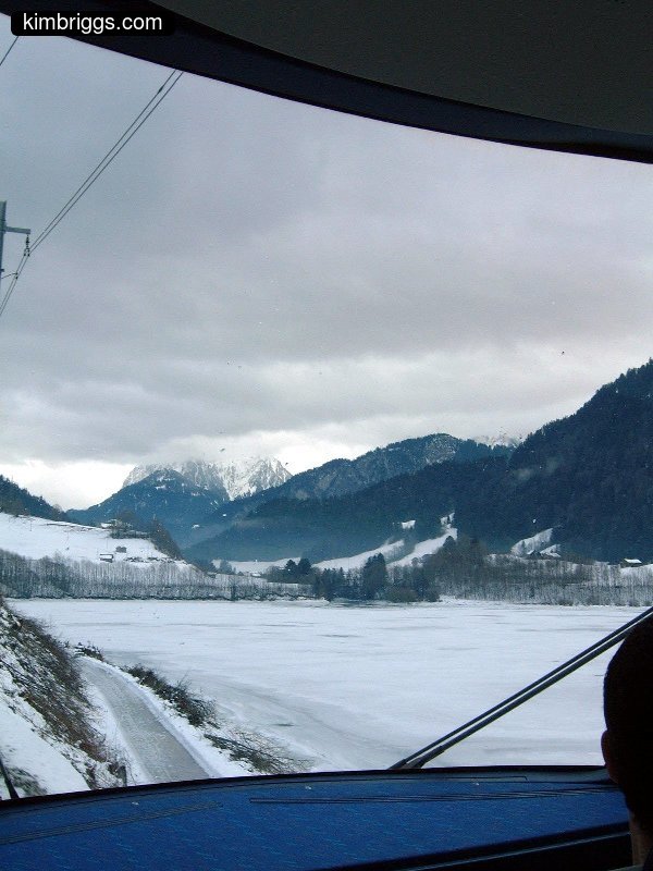 View from train of snowy field.