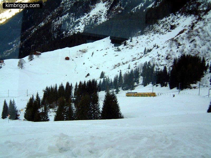Jungfraujoch cog train on snowy mountain pass.