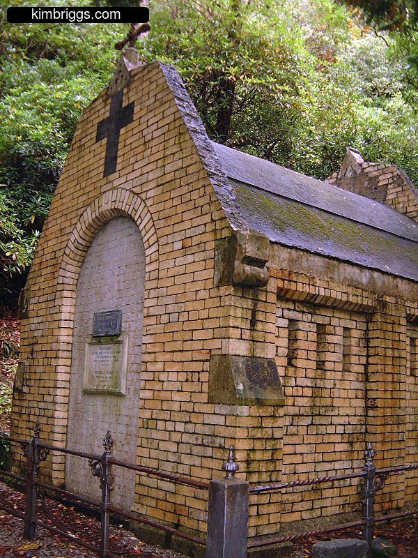 Tan brick building with cross on top.