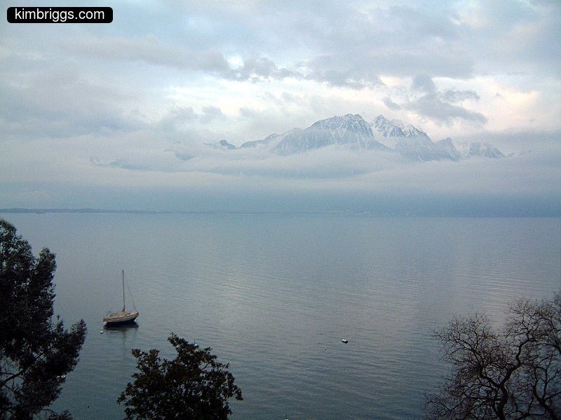 Mountains covered in fog and clouds on Lake Geneva.