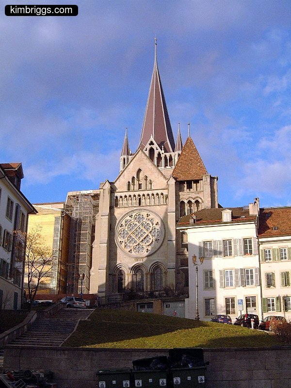 Old stone church with pointy steeples.