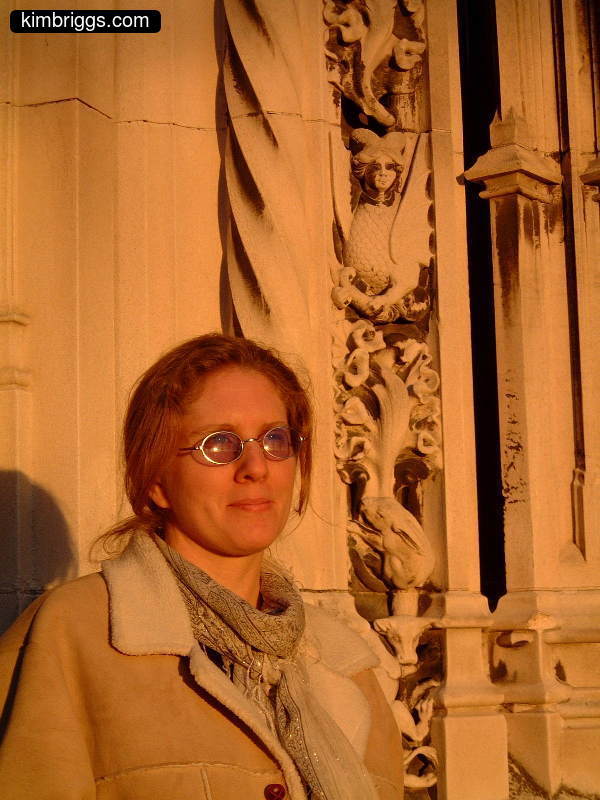 Woman with glasses colored by sunset.