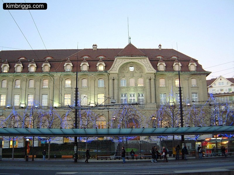 European building with blue holiday lights.
