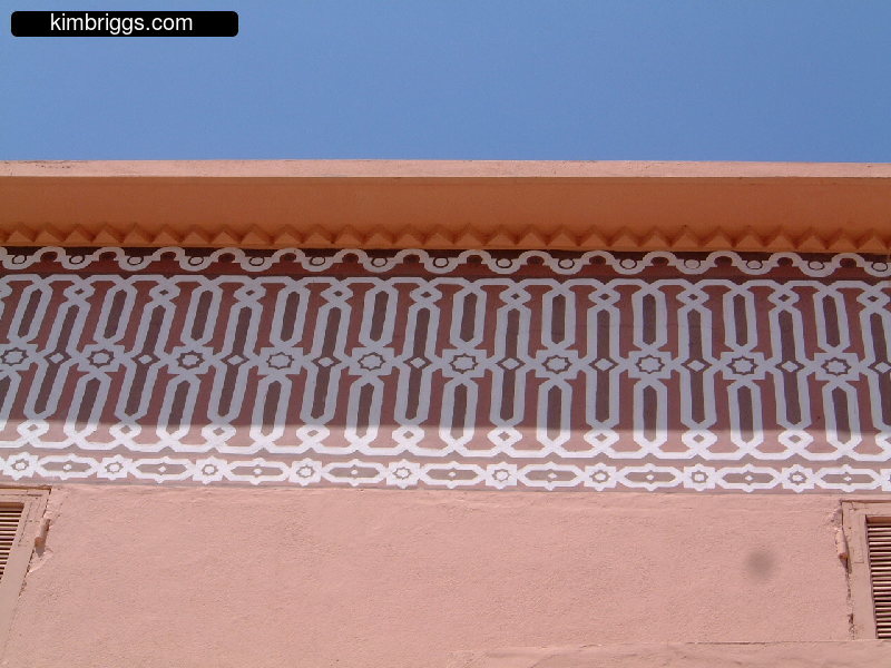 Whited decorative painting on red building.