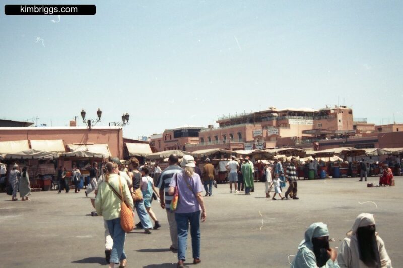 Tourists in outdoor souk in Marrakech Morocco.