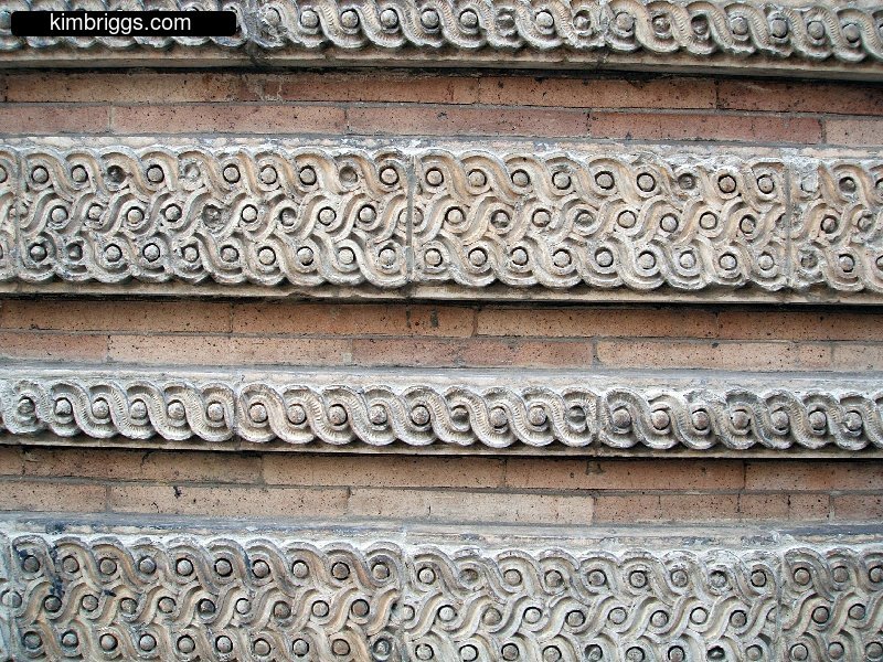 Artistic cement patterns on a wall.