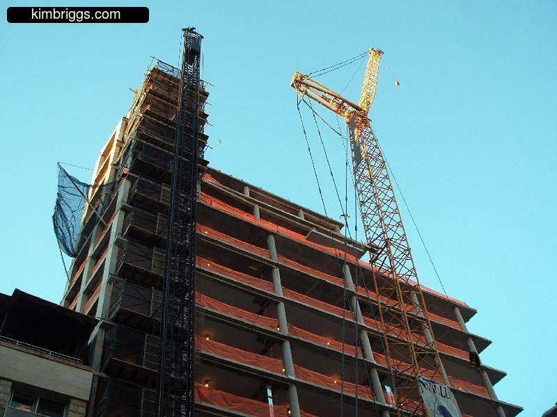 Large construction crane building a skyscraper.