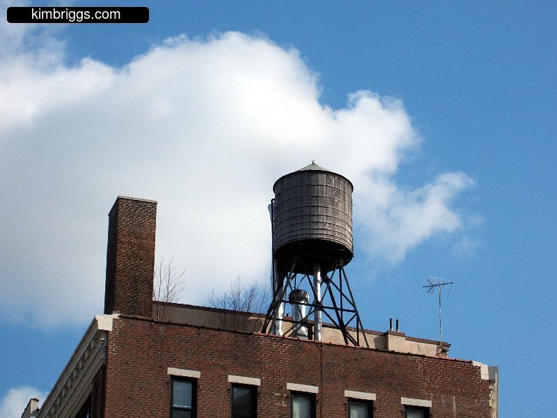 Wooden water tower on New York City roof.