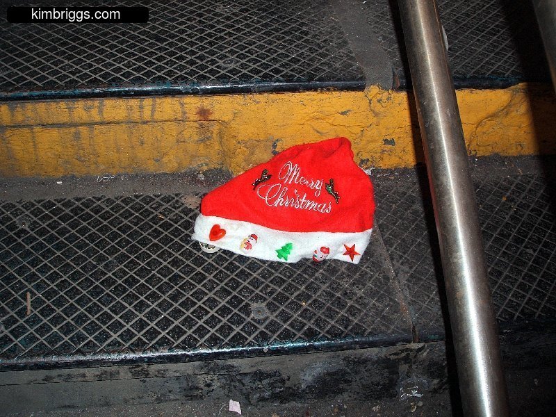 Dirty Christmas hat on subway steps.
