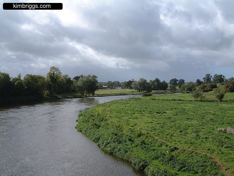 Small brook with green grass on banks.