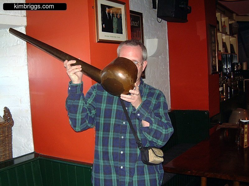 Man drinking from giant ladel.