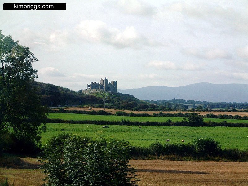 Rock of Cashel from across green field.