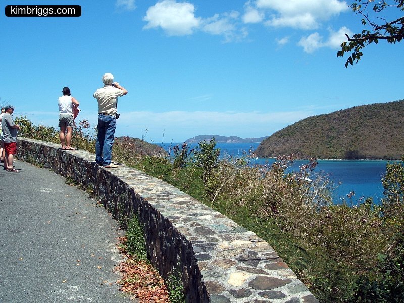 People at pull-out scenic view on tropical island.