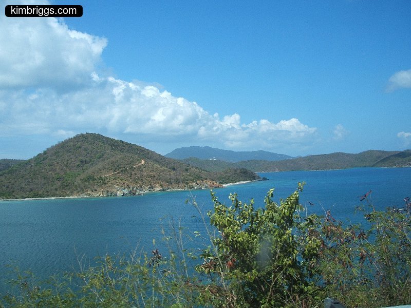 Blue sky, green islands, and blue water.