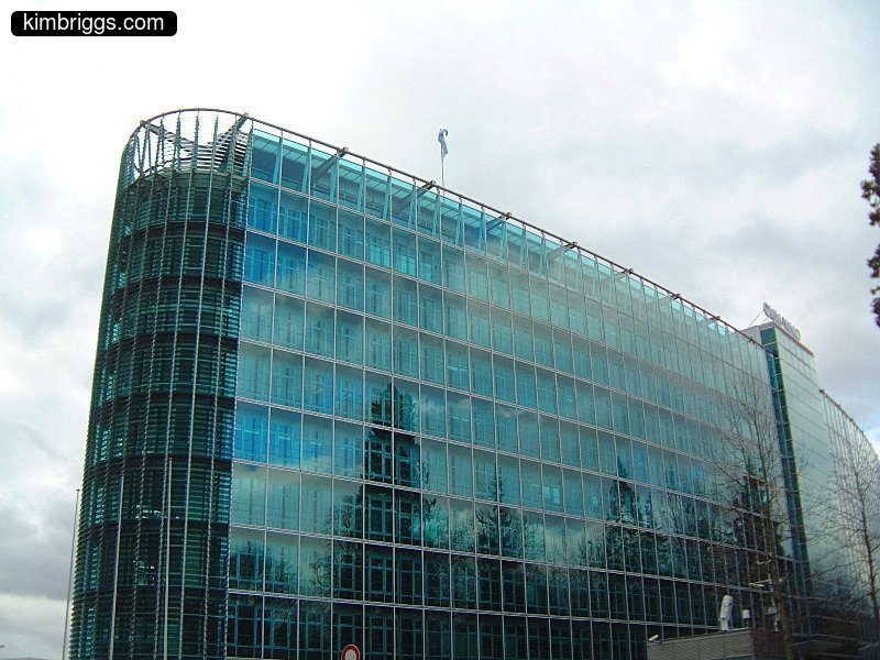 All glass building with rounded front.
