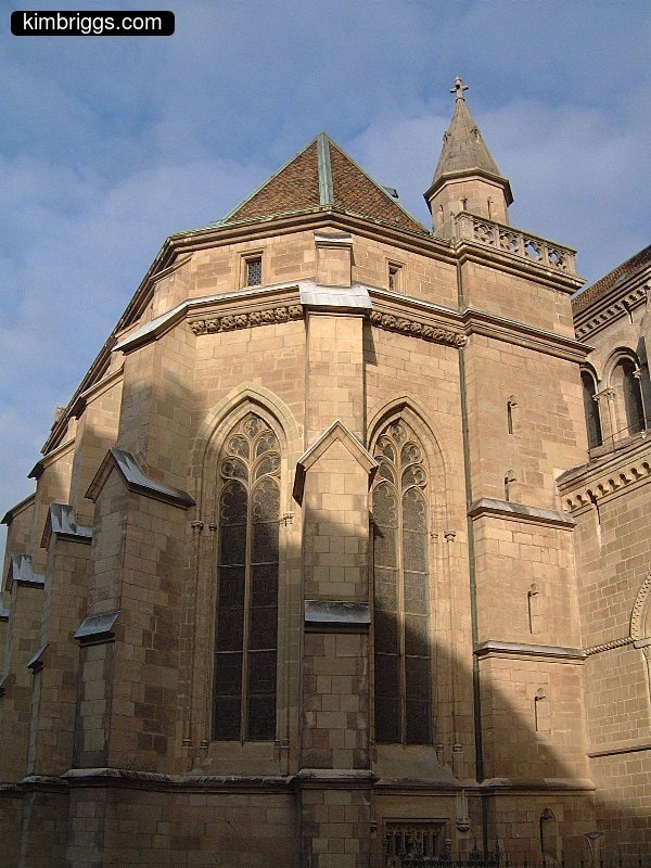 Stone church with tall Gothic windows.
