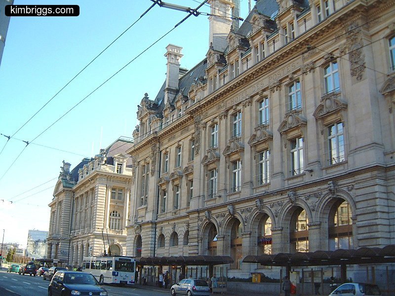 Large stone building with 1st floor arched windows.