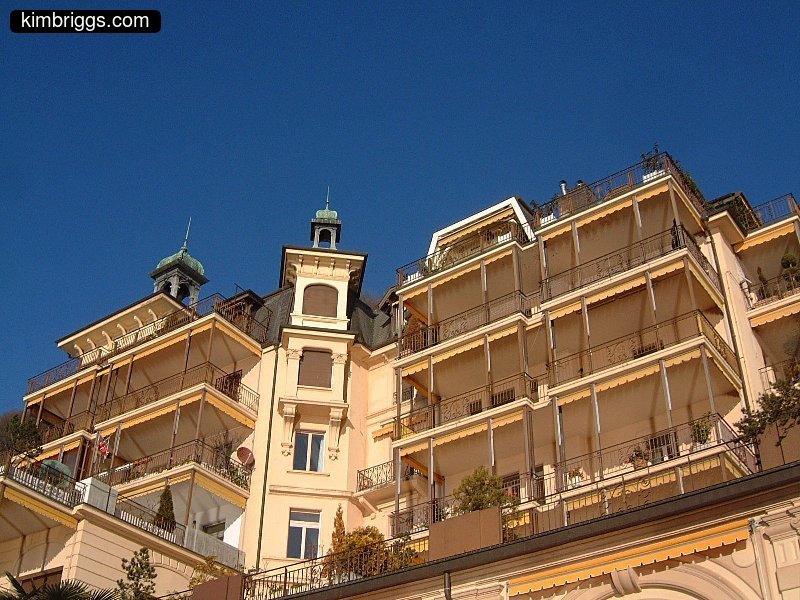 White porches against bright blue sky.