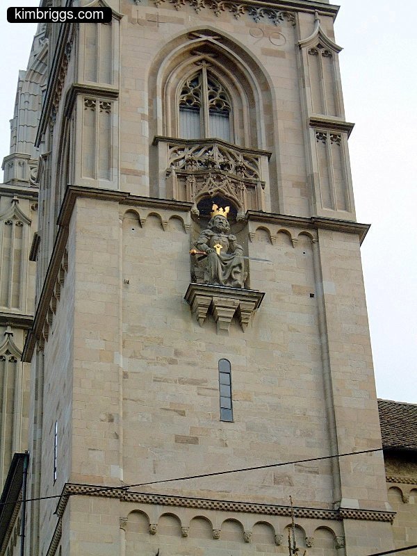 Statue of a king inside of church exterior wall.