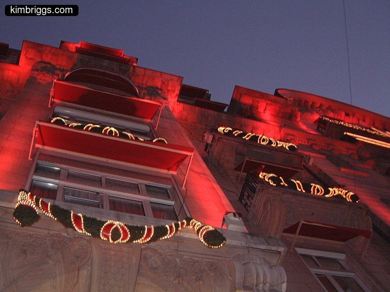 Building facade lit up with red lights.